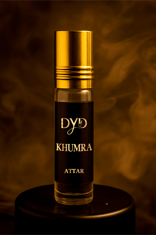 Bottle of KHUMRA attar, showcasing soft musk fragrance with a warm, inviting glow.